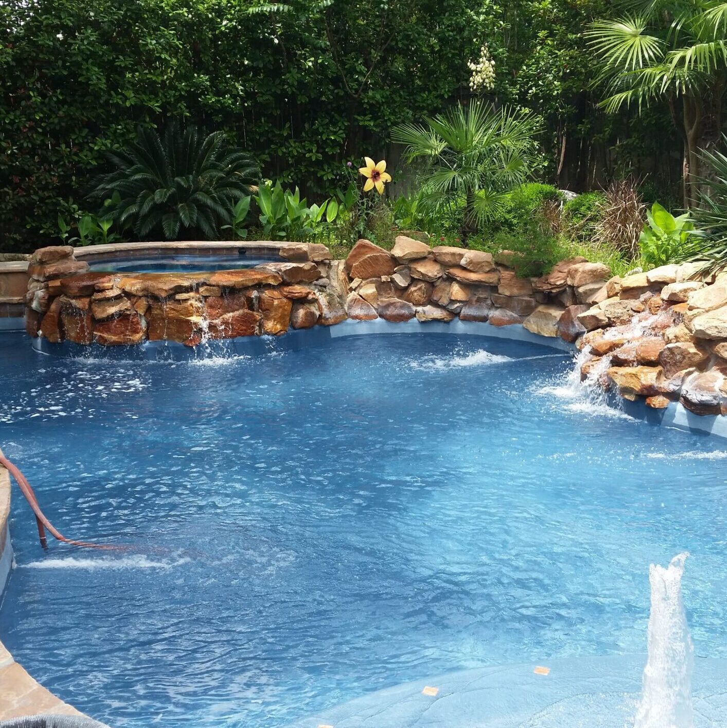 Natural pool and spa with rock feature